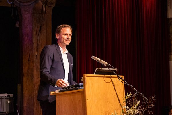 Vizepräsident Prof. Dr. Gunnar Schubert spricht am Rednerpult und schaut in einen Saal mit viel Publikum.