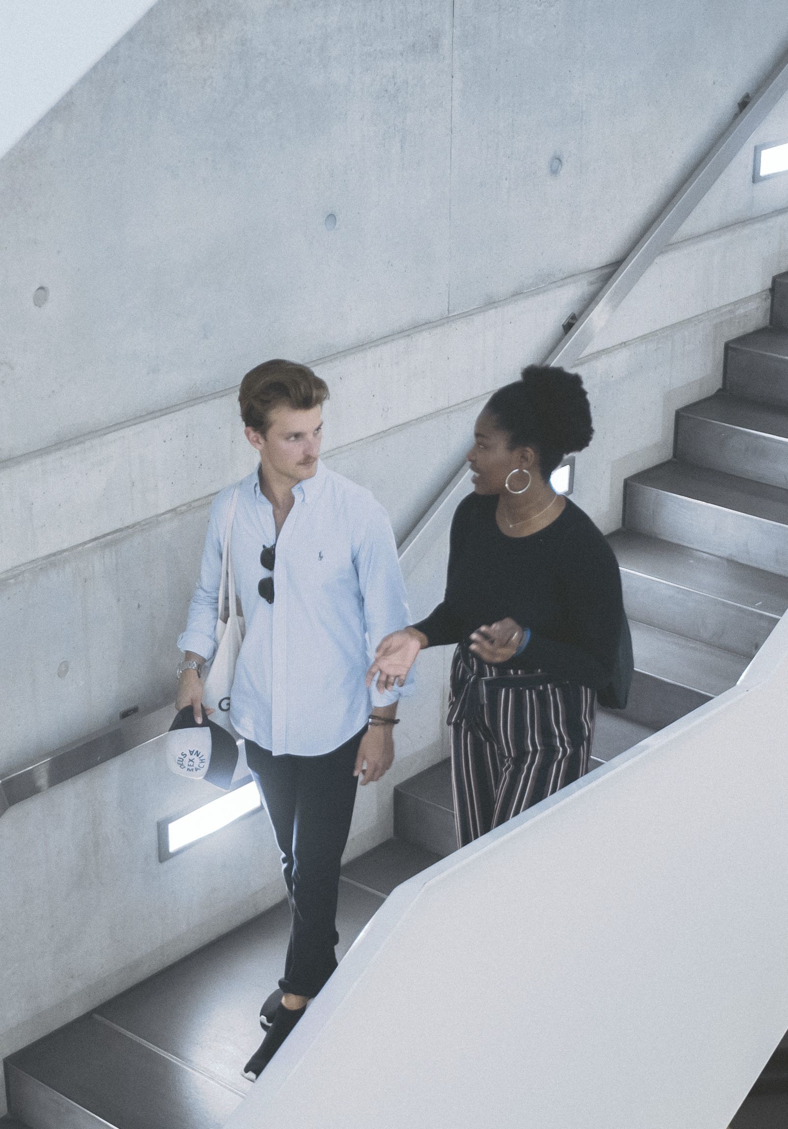 Two students are chatting while walking through school