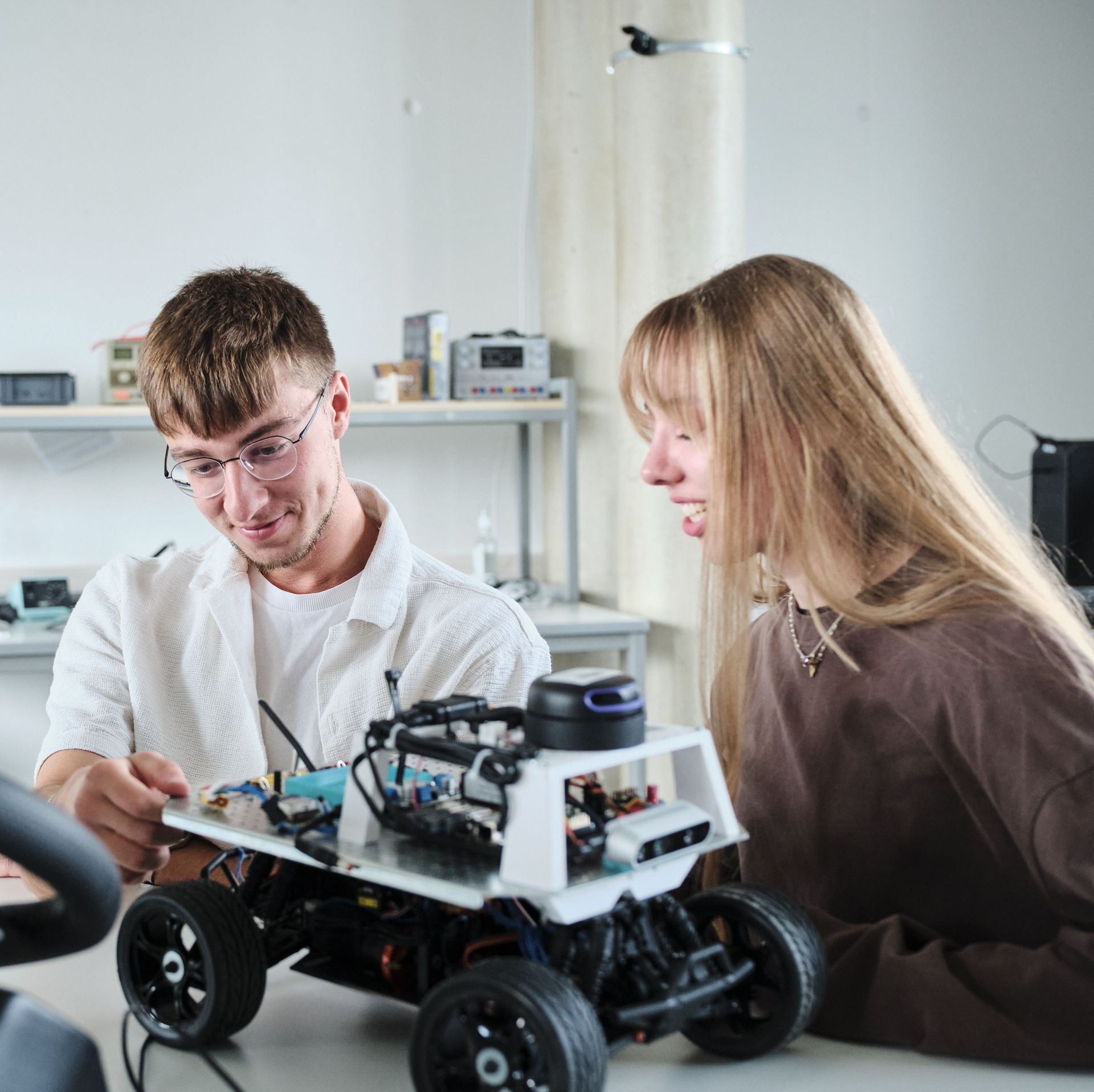 Students working with a small car model