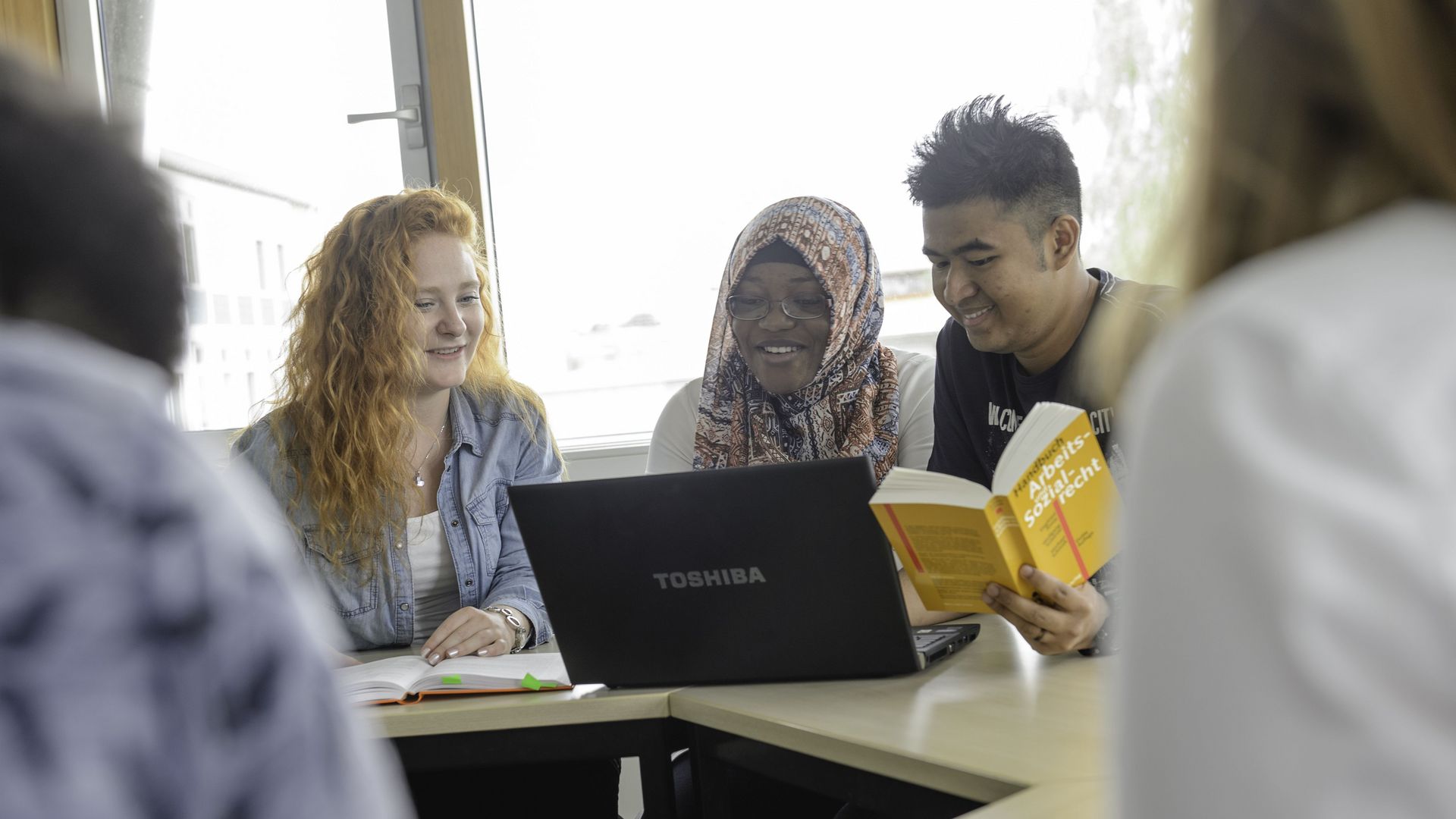 Studierende unterschiedlicher Herkunft arbeiten an einem Projekt