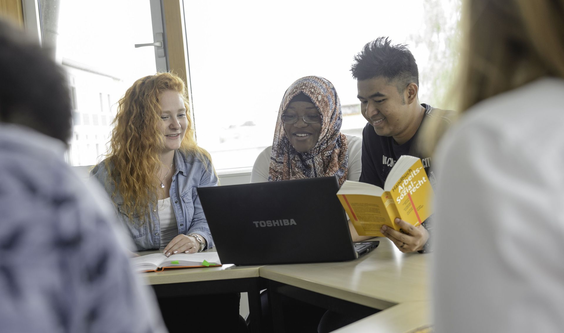 Studierende unterschiedlicher Herkunft arbeiten an einem Projekt