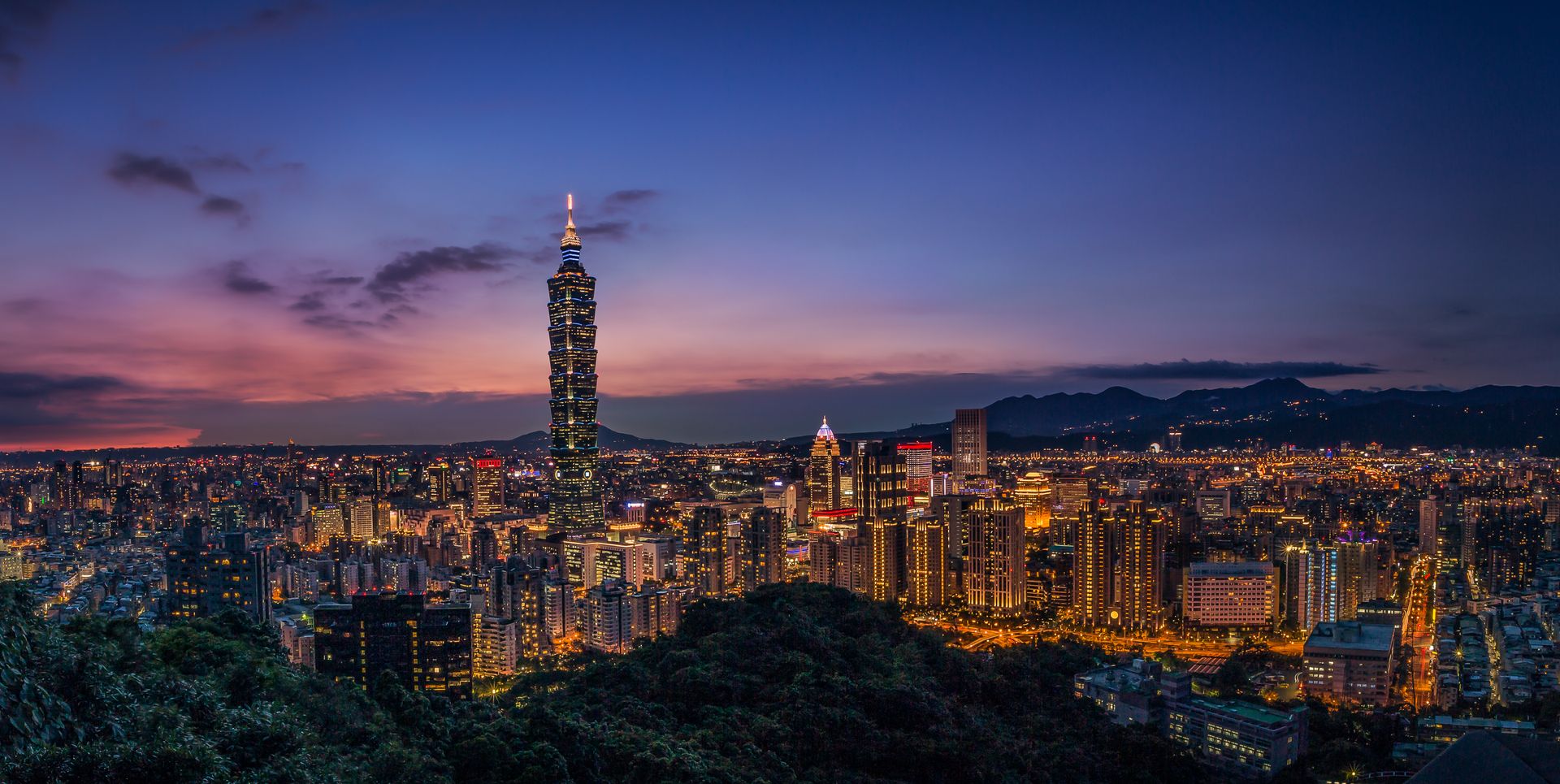 The glittering skyline of Taipei at dusk.