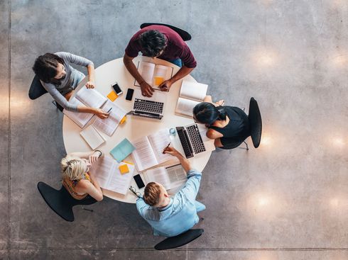 Five students studying together. Bird's-eye view.