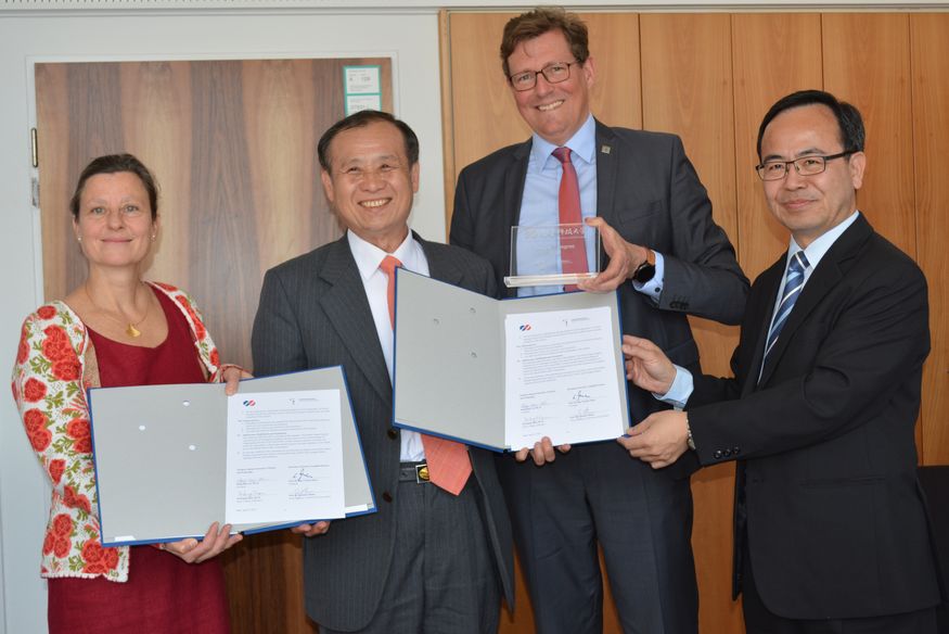 Gruppenfoto. Von links: Prof. Dr. Gabriele Thelen, Dekanin der Fakultät Wirtschafts-, Kultur- und Rechtswissenschaften, Dr. Deng Maw Lu, Präsident der STUST, Prof. Dr. Carsten Manz (Präsident der HTWG) und Dr. Te-Kuang Chou, Dekan der Wirtschaftsfakultät halten gemeinsam zwei Mappen mit Verträgen hoch..