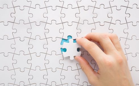 The last white piece of the jigsaw is being fitted into the jigsaw. Image credit: iStock.