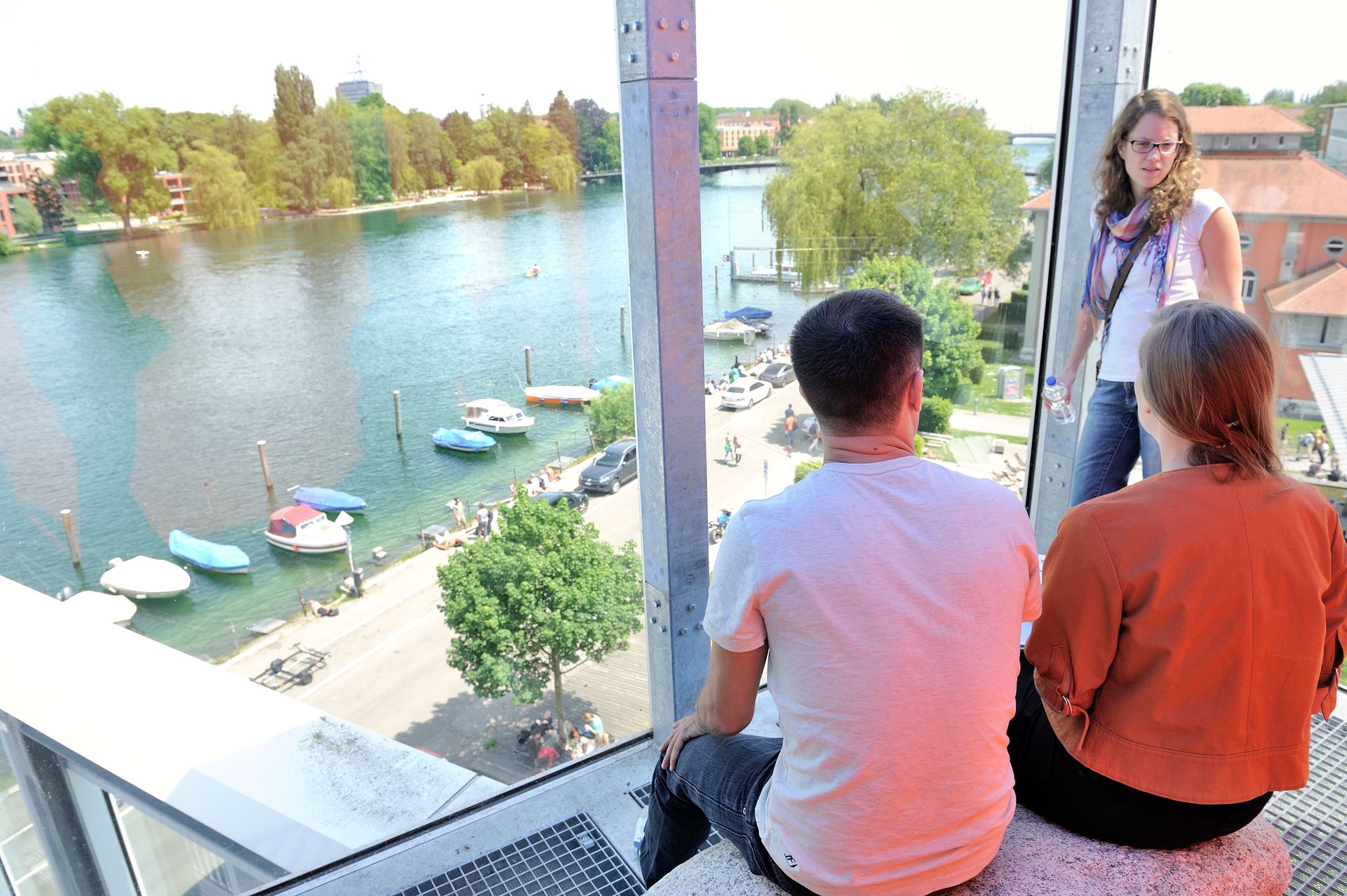 Studierende im verglasten Dachatelier der HTWG mit Blick auf den Seerhein und die Boote der Fakultät EI