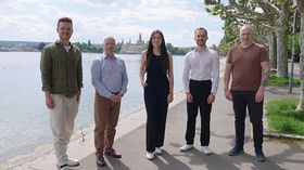 Fünf Personen stehen nebeneinander auf einer Uferpromenade, im Hintergrund der Bodensee und die Konstanzer Altstadt