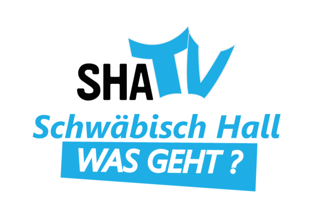Logo von "SHATV": "SHA" ist in schwarz geschrieben, daneben steht "TV" in blauer Schrift. Darunter "Schwäbisch Hall" und darunter "Was Geht?" in weißer Schrift auf blauen Untergrund.