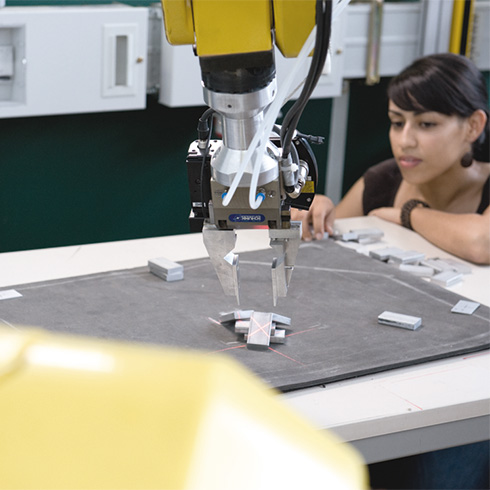 Female Student with industrial robot