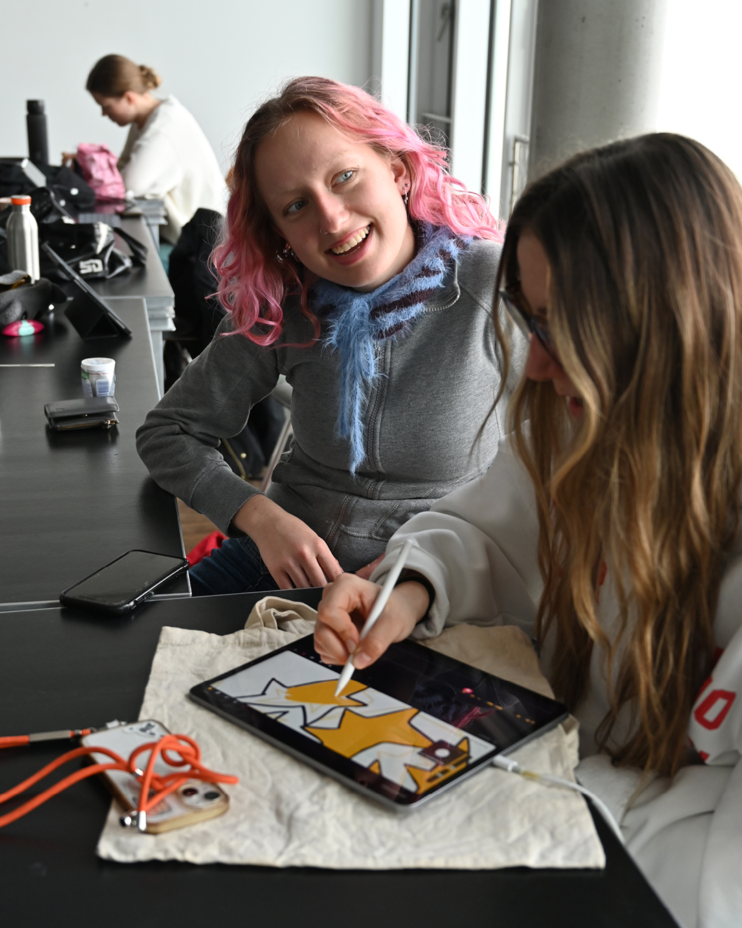 Studierende arbeiten gemeinsam an Aufgaben.