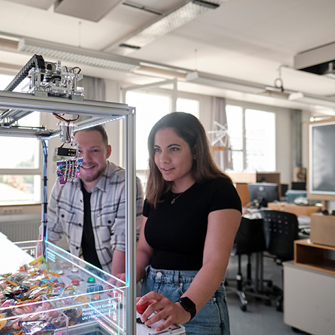 Two students testing their self-built candygrabber