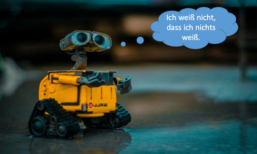 gelber Roboter mit Kamera-Kopf und ergänzter Sprechblase "Ich weiß nicht, dass ich nichts weiß."