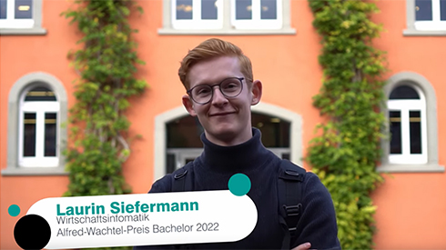 Eine Person ist bis einschließlich Schultern zu sehen, im Vordergrund Text "Laurin Siefermann, Wirtschaftsinformatik, Alfred-Wachtel-Preis Bachelor 2022", im Hintergrund ein orangefarbenes Gebäude mit vielen weißen Fenstern und Wandbegrünung