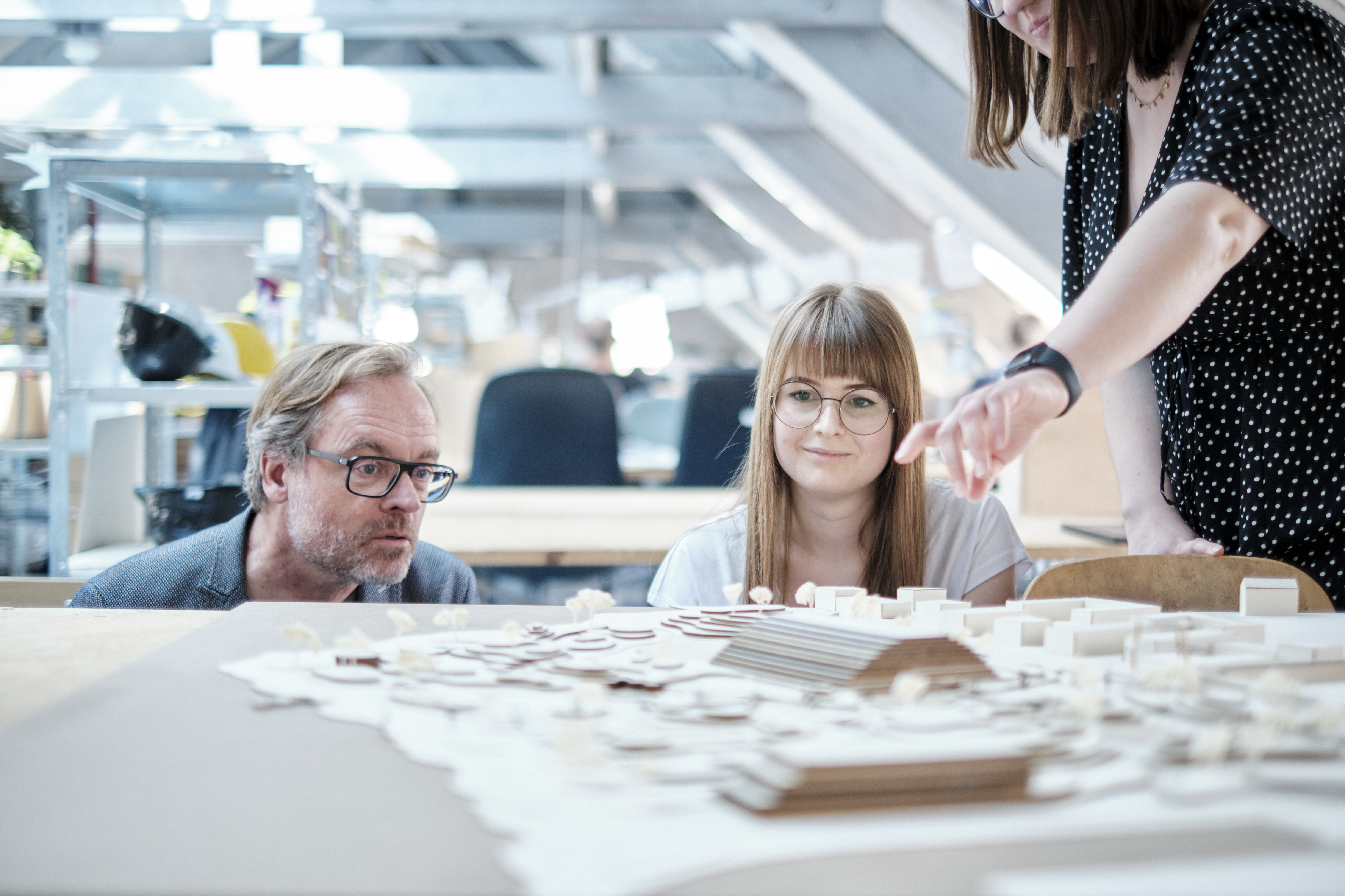 Auf em Foto Stehen Studierende und ein Lehrender um ein Stadtmodell