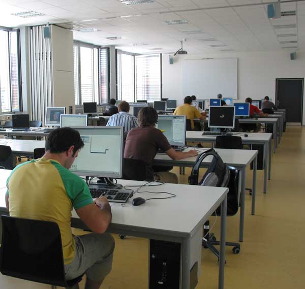 In einem PC-Poolraum sitzen mehrere Studierende vor den PCs.