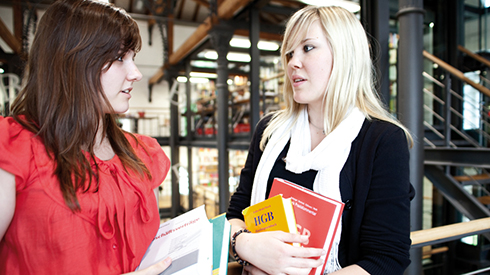 Two students interacting in the library